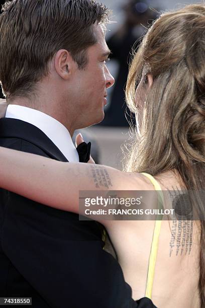 Actors Brad Pitt and Angelina Jolie pose 24 May 2007 upon arriving at the Festival Palace in Cannes, southern France, for the premiere of US director...