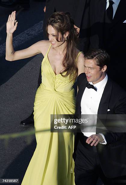 Actress Angelina Jolie wave to the crowd 24 May 2007 upon arriving with fellow counterpart Brad Pitt at the Festival Palace in Cannes, southern...