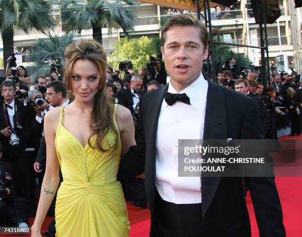 Actress Angelina Jolie and actor and producer Brad Pitt arrive 24 May 2007 at the Festival Palace in Cannes, southern France, for the premiere of US...