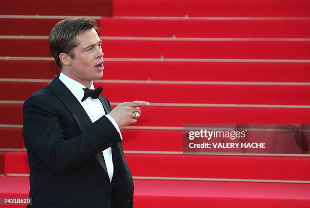 Actor and producer Brad Pitt gestures 24 May 2007 upon arriving at the Festival Palace in Cannes, southern France, for the premiere of US director...