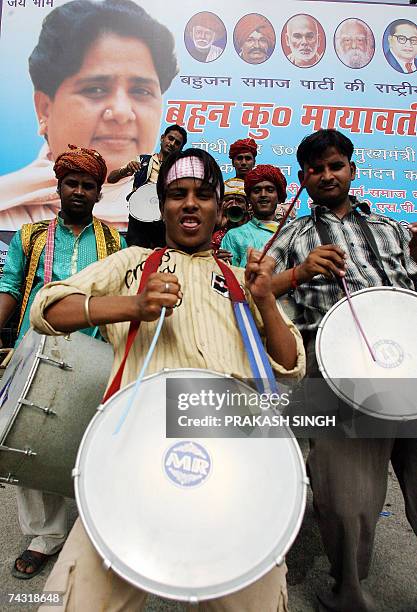 Indian folk musicians play outside the Bahujan Samaj Party office prior to a ceremony to congratulate the new Chief Minister of the Indian state of...