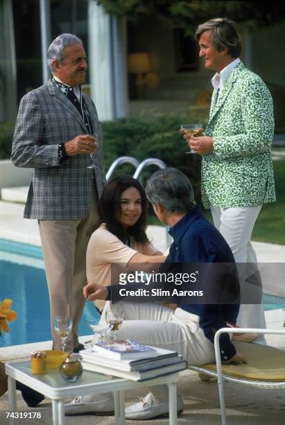 American industrial designer Raymond Loewy and his wife Viola Erickson at a poolside party at the Desert House Inn, Palm Springs, California, 1970.