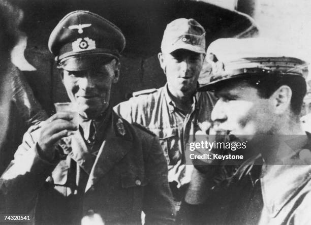 German military commander Erwin Rommel drinks to victory at El Alamein in Egypt during World War II, 1942. This photograph was found on a captured...