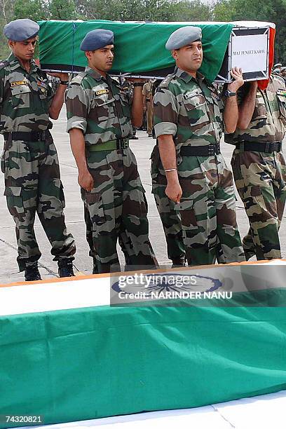 Indian army personnel pay tribute at the coffins of Indian Air Force pilots Lieutenant Colonel D Kunha and Major Puneet Karoon who died in a...