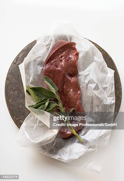 a slice of calf's liver with sage on paper - beef liver stock pictures, royalty-free photos & images