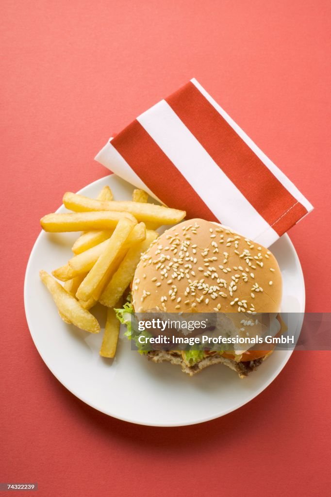 Cheeseburger, bites taken, with chips