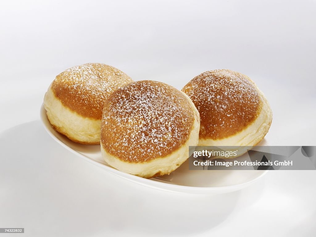 Three doughnuts on a serving plate