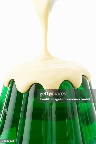 pouring custard over woodruff jelly - custard stock pictures, royalty-free photos & images