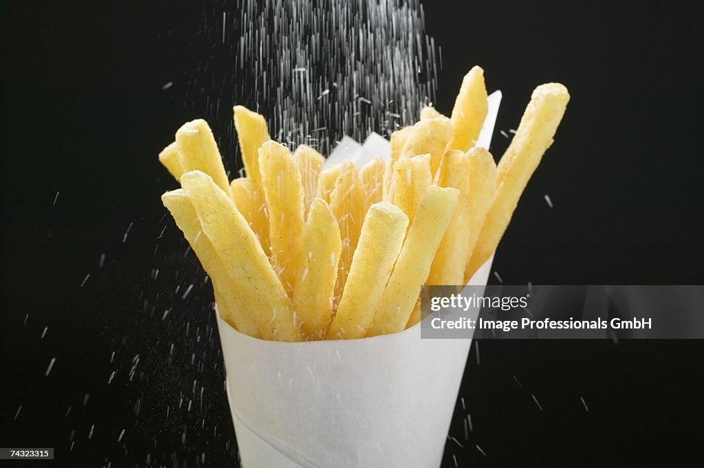 Sprinkling salt over chips