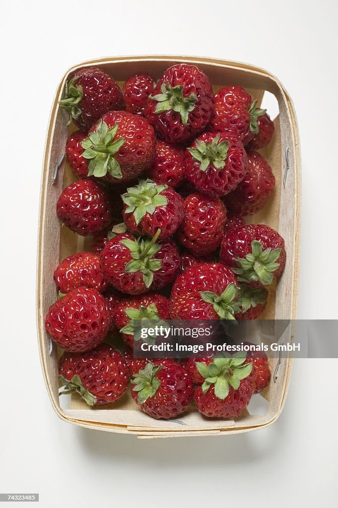 Fresh strawberries in woodchip basket