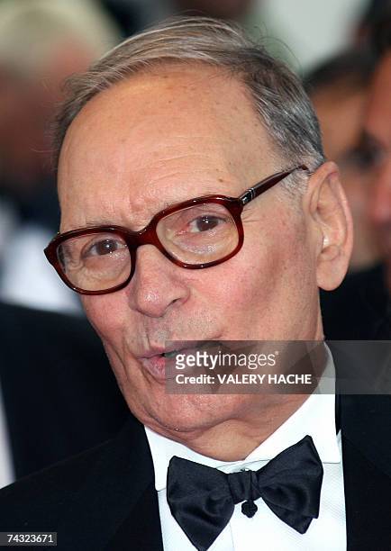 Italian composer Ennio Morricone poses 25 May 2007 upon arriving at the Festival Palace in Cannes, southern France, for the premiere of US director...