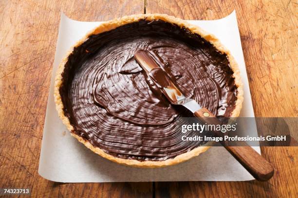 spreading pastry case with chocolate - pastry case stock pictures, royalty-free photos & images