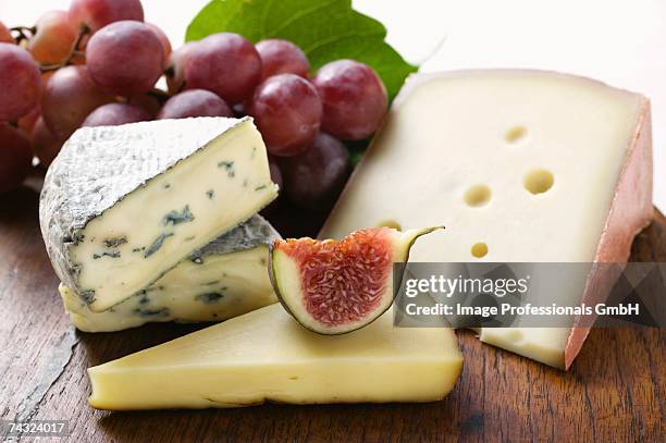 cheese still life with fig and grapes - red grapes stock pictures, royalty-free photos & images