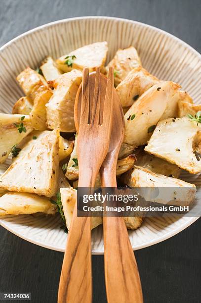 roasted chunks of celeriac in dish - apio nabo fotografías e imágenes de stock