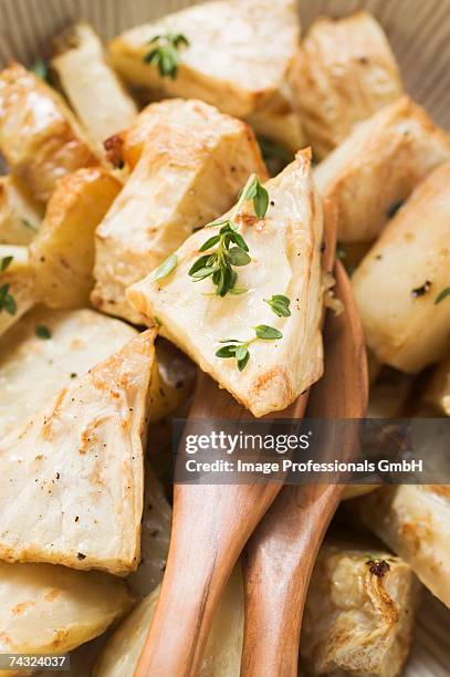 roasted chunks of celeriac in dish (detail) - apio nabo fotografías e imágenes de stock