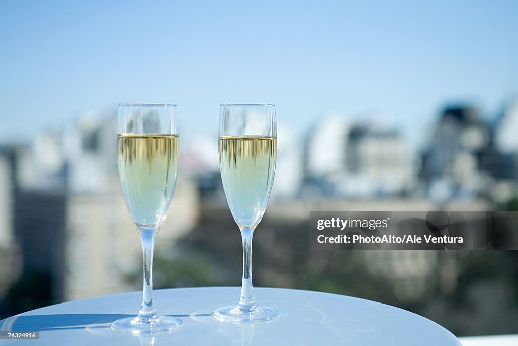 Two glasses of champagne and city skyline