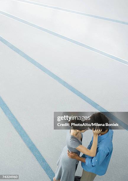 young couple embracing, high angle view - high forehead stock pictures, royalty-free photos & images