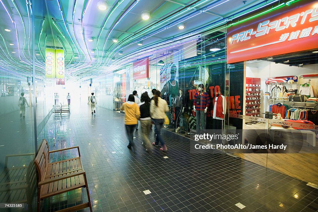 Shoppers walking through mall