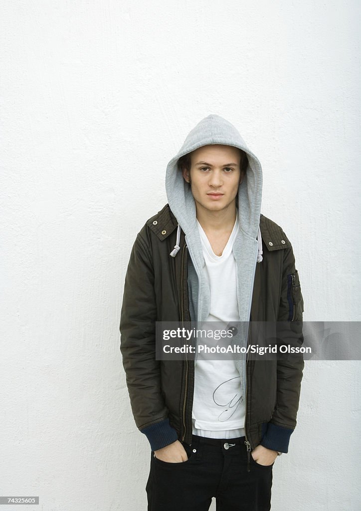 Young man with hands in pockets, portrait