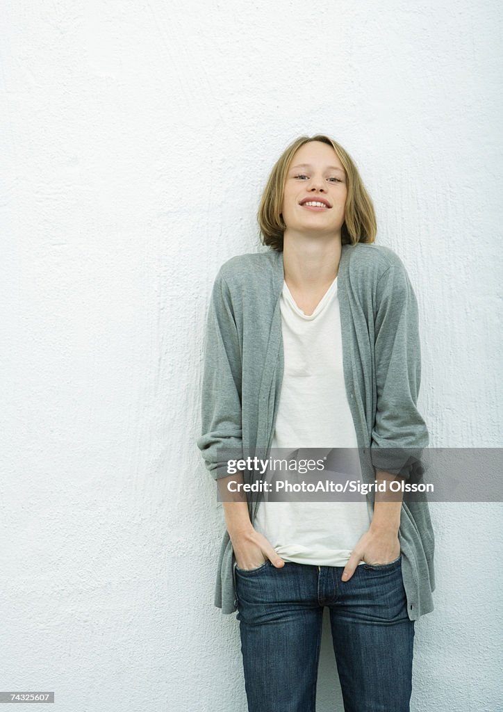 Teenage girl with hands in pockets, portrait