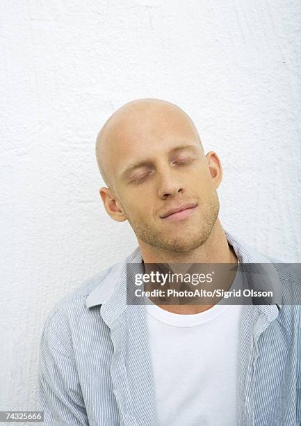 young man with eyes closed, portrait - baldness stock pictures, royalty-free photos & images