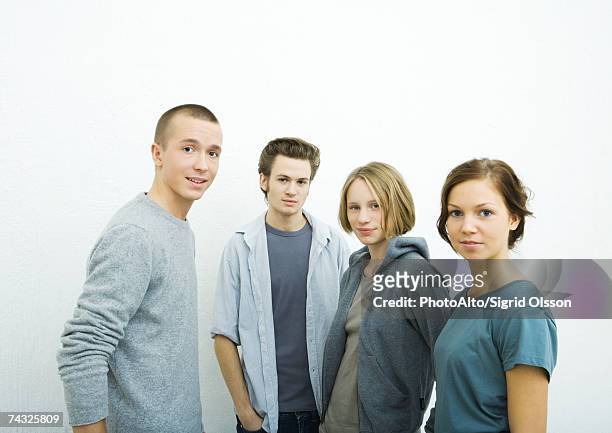 four young friends, looking at camera, portrait - four people stockfoto's en -beelden