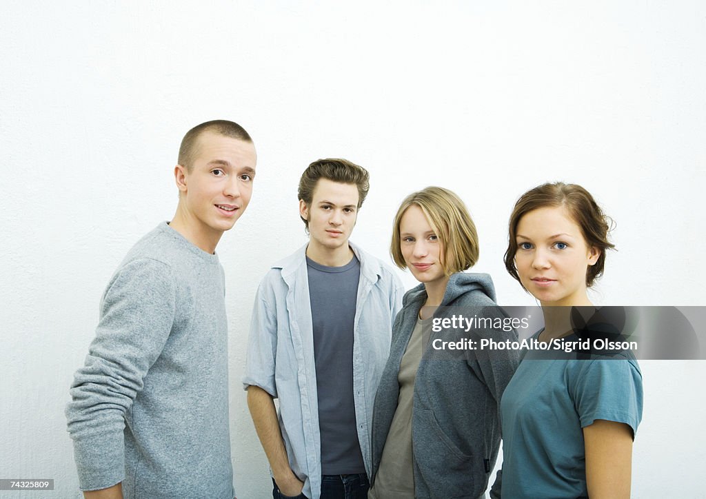 Four young friends, looking at camera, portrait