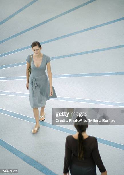 two women walking by each other - a line dress stock pictures, royalty-free photos & images