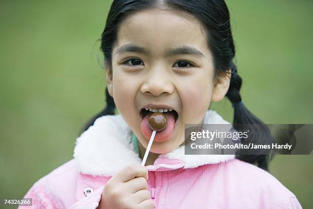 girl eating lollipop - open day 7 stock pictures, royalty-free photos & images