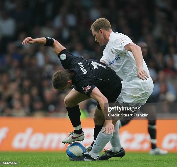 Marvin Braun of St. Pauli is challenged by Daniel Ernmenn of Dresden during the Third League Northern Division match between FC St.Pauli and Dynamo...