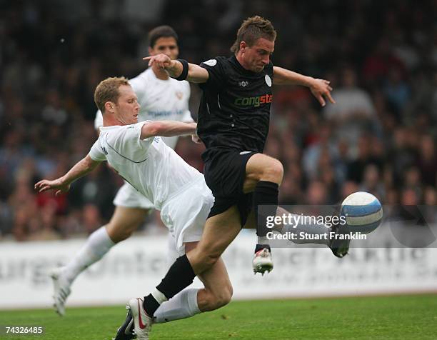 Marvin Braun of St. Pauli is challenged by Daniel Ernmenn of Dresden and thus leading to the penalty during the Third League Northern Division match...