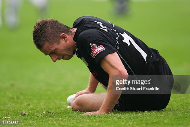 Marvin Braun of St. Pauli holds his leg as he sits on the ground during the Third League Northern Division match between FC St.Pauli and Dynamo...