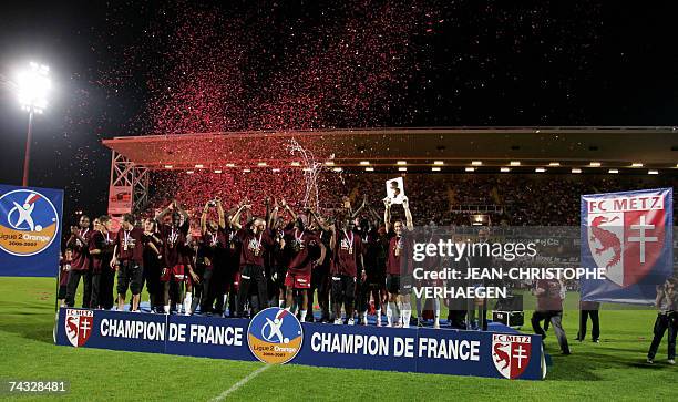 Longeville-les-Metz, FRANCE: Metz's players stand on a the podium jubilating after they won their French L2 football match at Saint Symphorien...