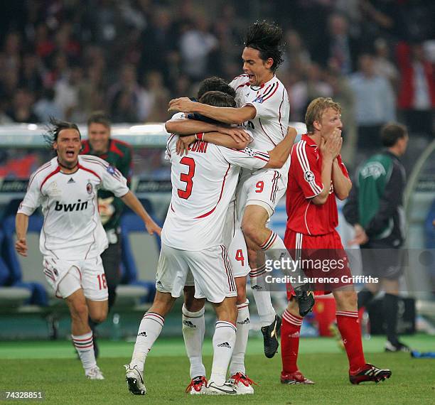 Filippo Inzaghi of AC Milan celebrates victory with Paolo Maldini on the final whistle in front of a dejected Dirk Kuyt of Liverpool during the UEFA...