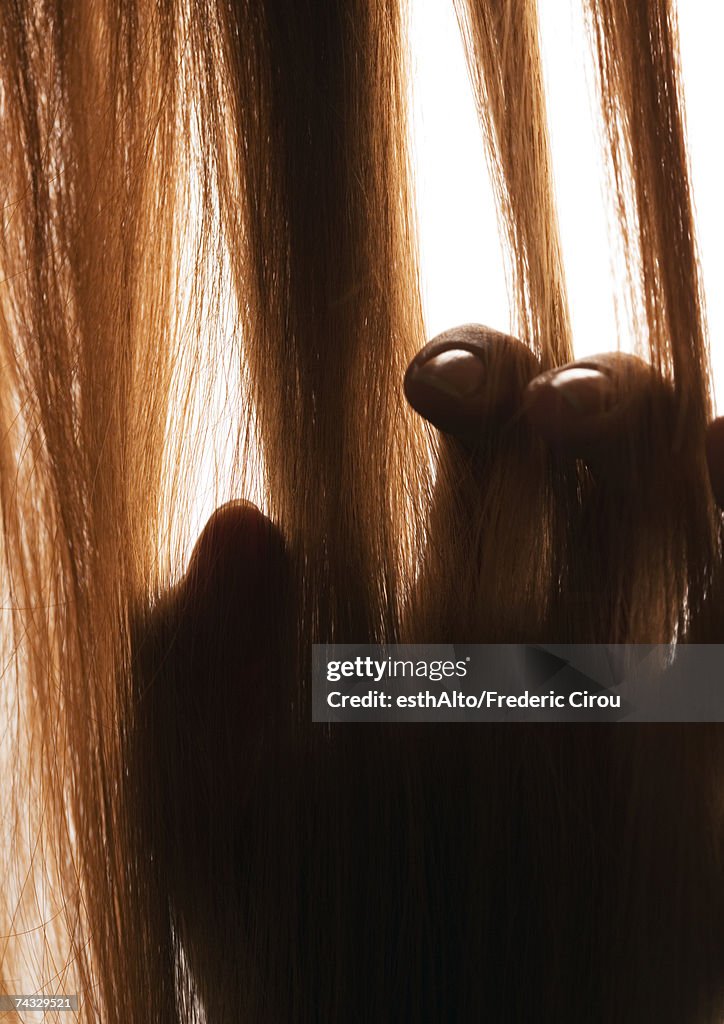 Woman touching hair, close-up