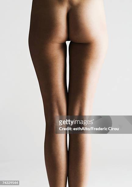 woman's bare buttocks and legs, rear view - bare bottom women stockfoto's en -beelden