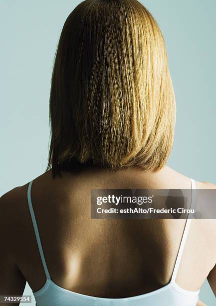 young woman with shoulder length hair, rear view - escapula fotografías e imágenes de stock