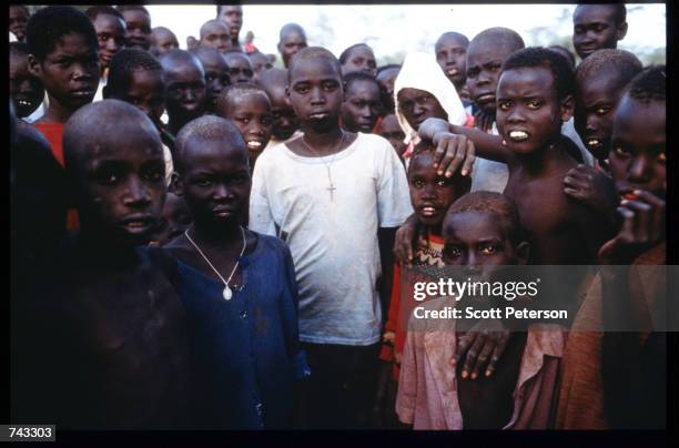 Sudanese refugees and "Lost Boys" huddle together on June 18, 1992 at a camp inside Kenya. Some 17,000 boys were lured away from home to receive...