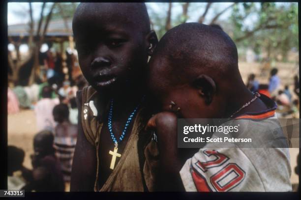 Sudanese "Lost Boy" leans on another boy on June 18, 1992 at a refugee camp inside Kenya. Some 17,000 boys were lured away from home to receive...