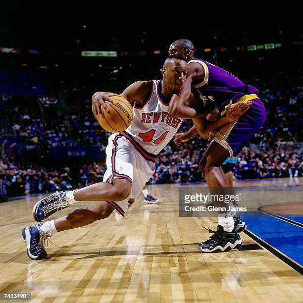 John Wallace of the Eastern Conference drives to the basket against Kobe Bryant of the Western Conference during warm-ups before the 1997 Rookie...