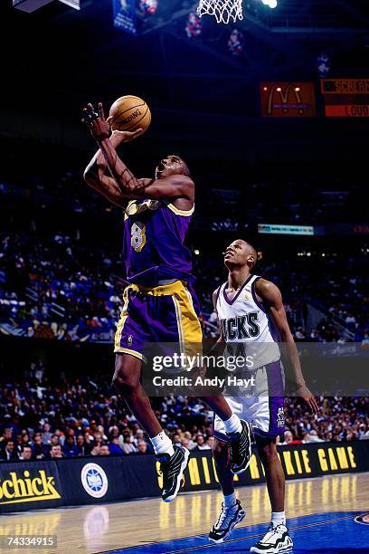 Kobe Bryant of the Western Conference attempts a layup against Ray Allen of the Eastern Conference during the 1997 Rookie All-Star game played...