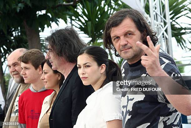 Sarajevo-born director Emir Kusturica shows three fingers 26 May 2007 as it is the third time he attends the festival's competition while posing with...