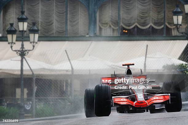 Fernando Alonso of Spain and McLaren Mercedes drives through Casino Square in the warm up session prior to qualifying for the Monaco Formula One...