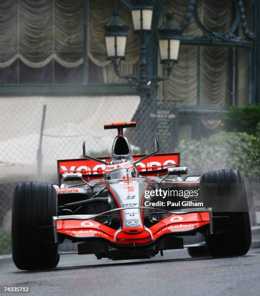 Fernando Alonso of Spain and McLaren Mercedes drives through Casino Square in the warm up session prior to qualifying for the Monaco Formula One...