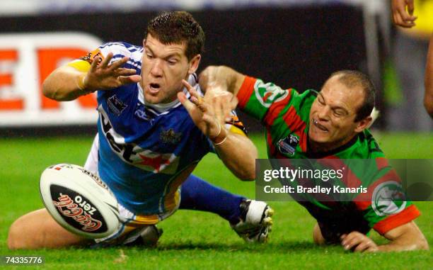 Brett Delaney of the Titans beats Reece Simmonds of the Rabbitohs to the ball to score a try during the round 11 NRL match between the Gold Coast...