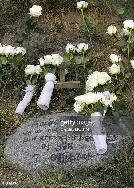 White roses given by visitors rest on the grave of moon bear "Andrew" after the unveiling cerenomy of a monument to the animal at Animals Asia?s Moon...