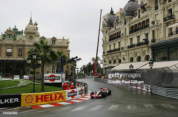 Fernando Alonso of Spain and McLaren Mercedes drives through Casino Square in the warm up session prior to qualifying for the Monaco Formula One...