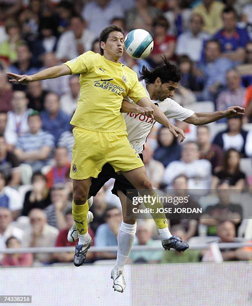 Valencia's Argentinian Fabian Ayala jumps for a header with Villarreal's Mexican Guille Franco during their Spanish league football match at the...