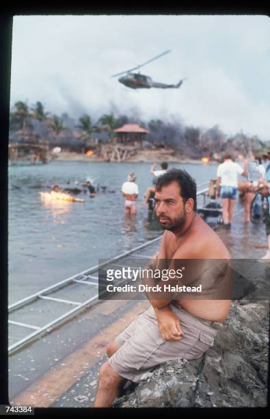 Director Francis Ford Coppola sits on a rock April 28, 1976 during the filming of 'Apocalypse Now' in the Philippines. The film is based on the novel...