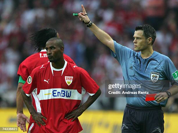 Referee Michael Weiner shows Cacau of Stuttgart, the red card, after a foul during the German Football Association Cup Final between VfB Stuttgart...